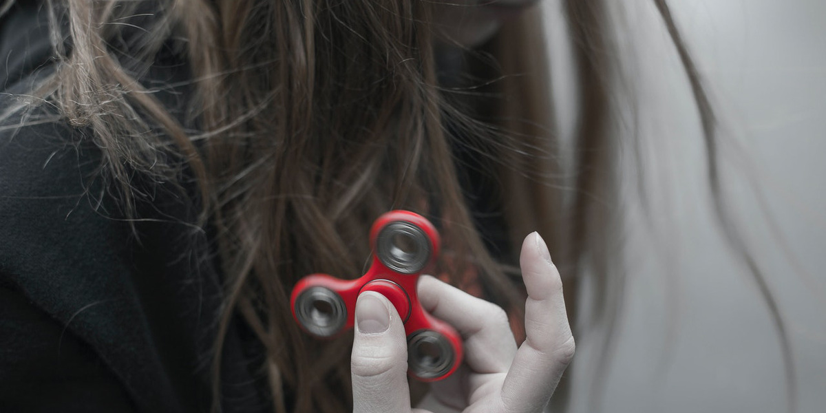 Woman Holding Red Hand Spinner
